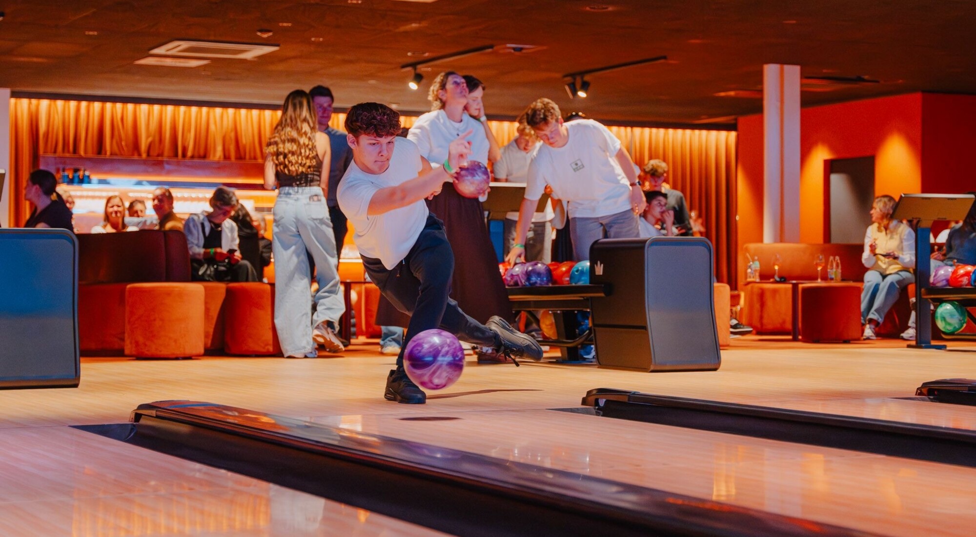 Jongen die aan het bowlen is.